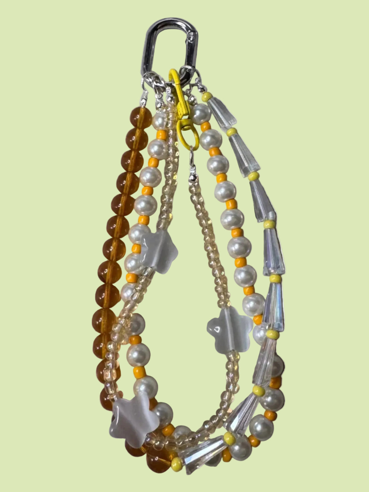 Handmade beaded bag charm keychain with a silver carabiner clip, featuring white faux pearls, translucent white beads, amber brown beads, and star quartz beads.