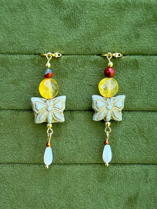 Handmade beaded earrings with gemstone and Czech glass beads on a olive green velvet background.