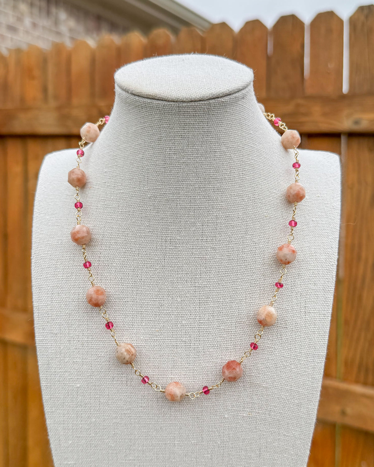 Beaded necklace featuring handmade wire links with sunstone gemstone beads and glass seed beads.