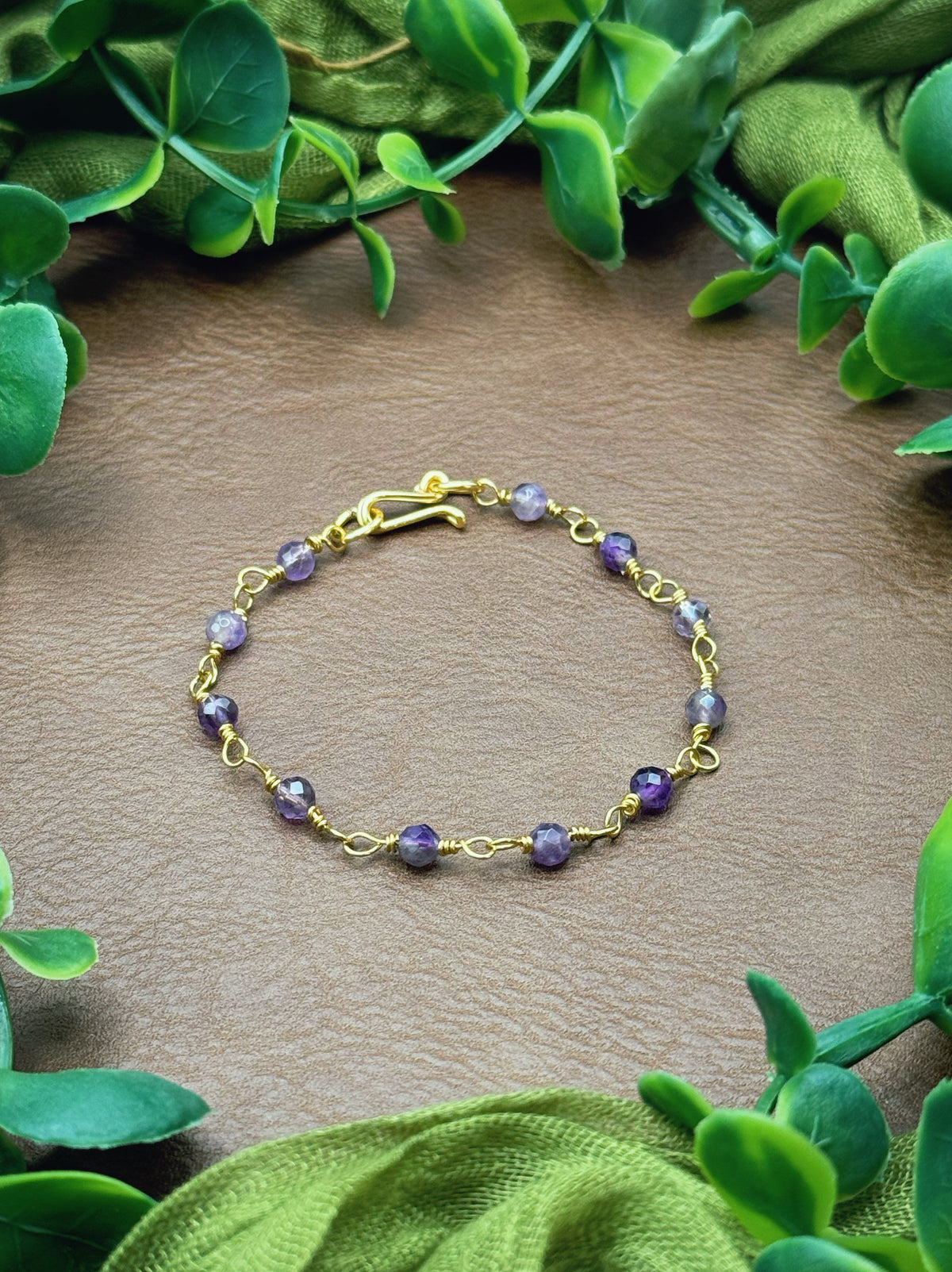 Handmade beaded chain bracelet featuring wire links and purple amethyst beads.