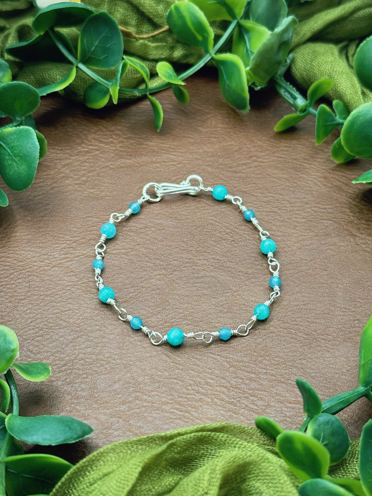 Handmade beaded chain bracelet featuring wire links and aqua and blue gemstone beads.