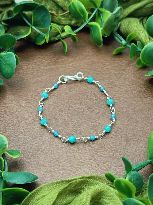 Handmade beaded chain bracelet featuring wire links and aqua and blue gemstone beads.