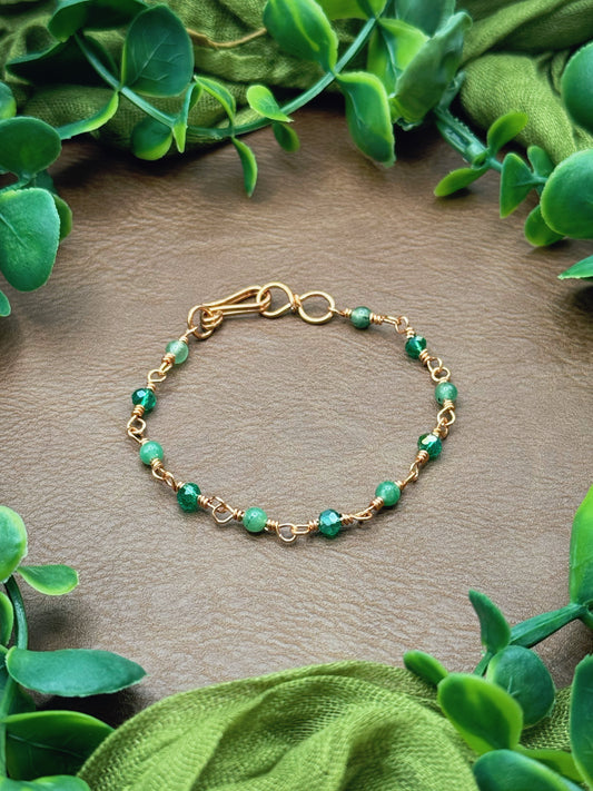 Handmade beaded chain bracelet featuring wire links and green gemstone and crystal beads.