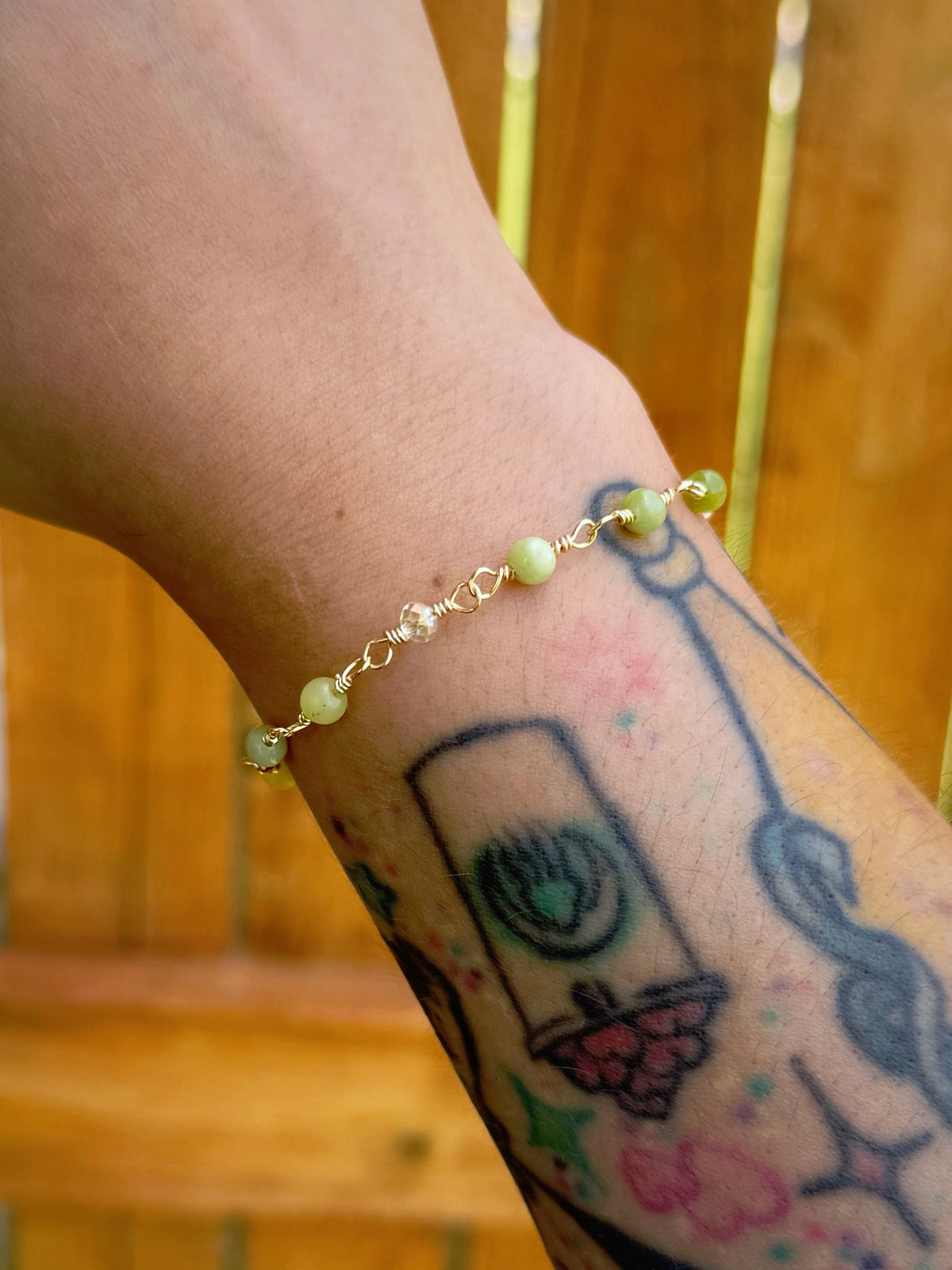 Handmade beaded chain bracelet featuring wire links with olive green and crystal beads.