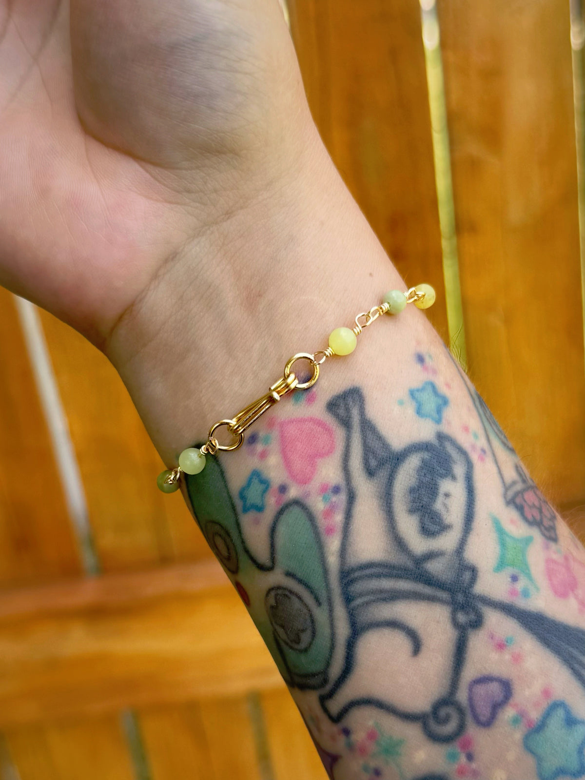 Handmade beaded chain bracelet featuring wire links with olive green and crystal beads.