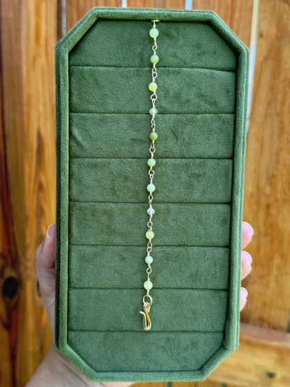 Handmade beaded chain bracelet featuring wire links with olive green and crystal beads.
