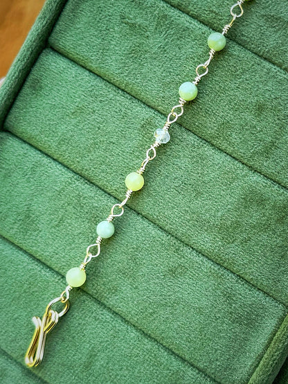 Handmade beaded chain bracelet featuring wire links with olive green and crystal beads.