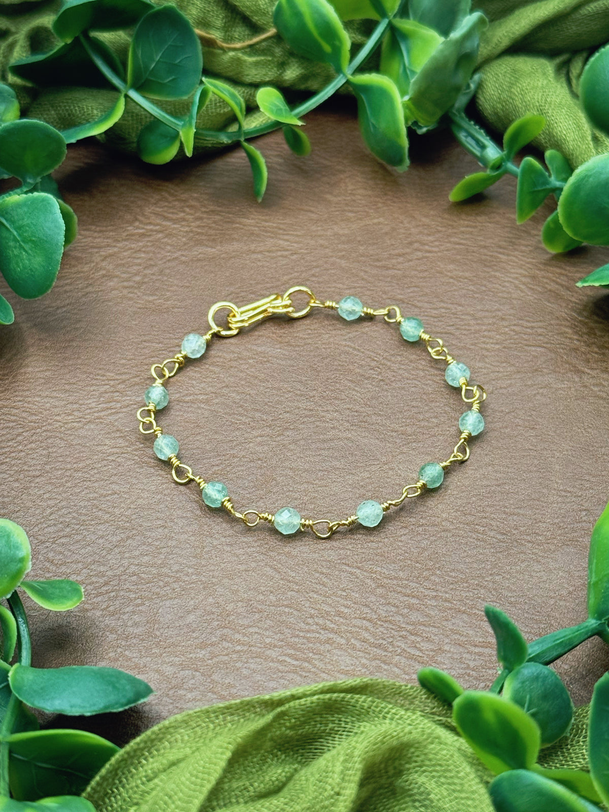 Handmade beaded chain bracelet featuring wire links with olive green and crystal beads.