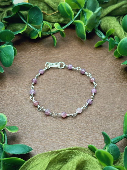 Handmade beaded chain bracelet featuring wire links and purplish pink lepidolite gemstone beads.