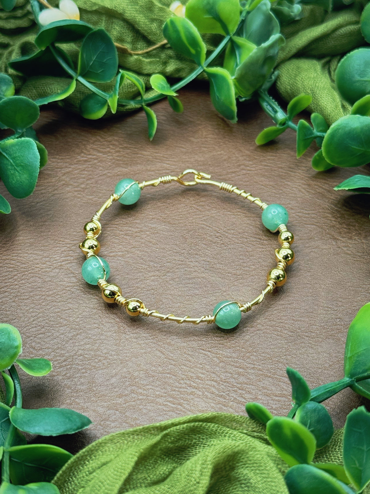 Handmade wire-wrapped bangle bracelet with quartz beads.