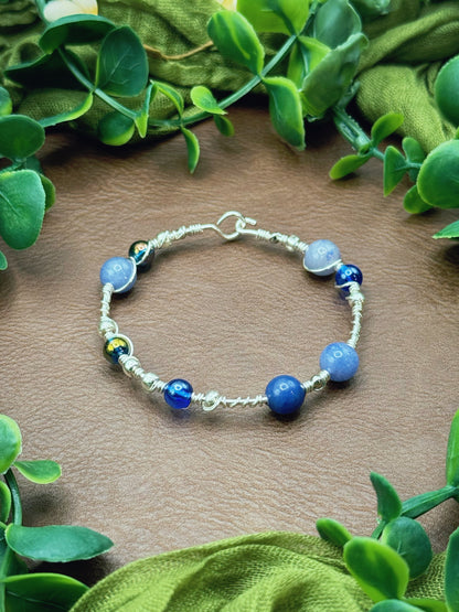 Handmade wire-wrapped bangle bracelet with quartz beads.