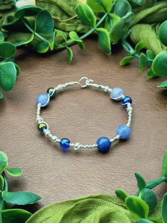 Handmade wire-wrapped bangle bracelet with quartz beads.