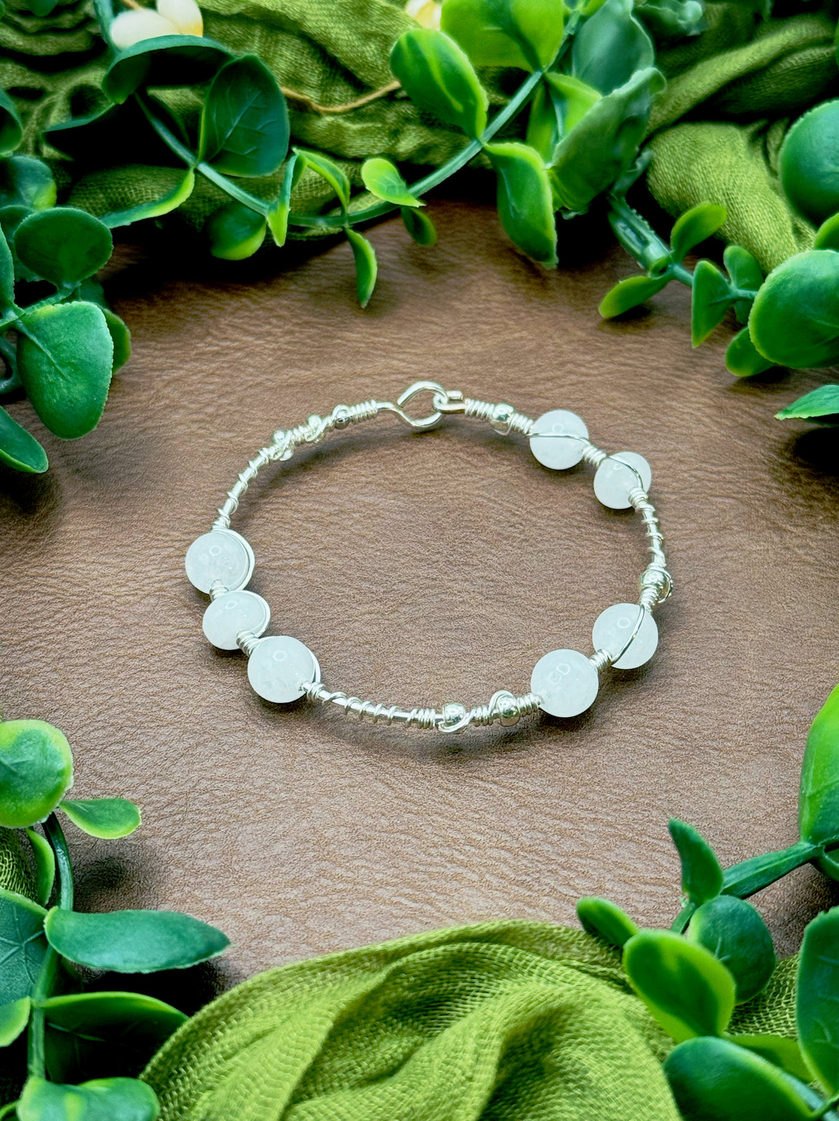 Handmade wire-wrapped bangle bracelet with quartz beads.
