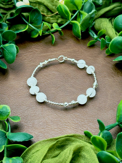 Handmade wire-wrapped bangle bracelet with quartz beads.