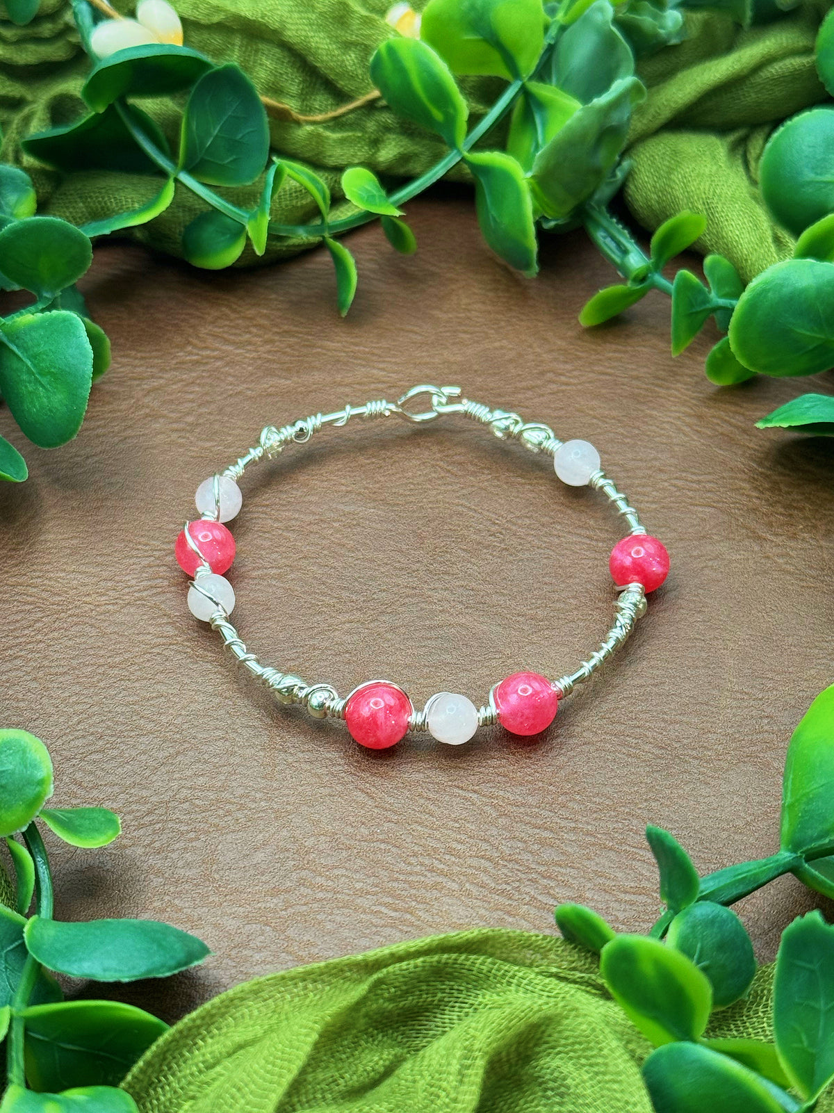 Handmade wire-wrapped bangle bracelet with quartz beads.