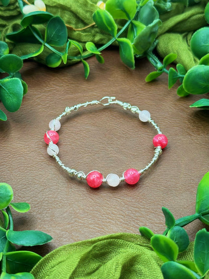 Handmade wire-wrapped bangle bracelet with quartz beads.