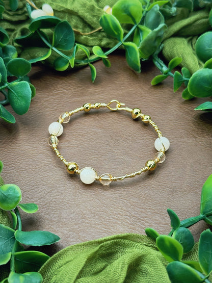 Handmade wire-wrapped bangle bracelet with quartz beads.