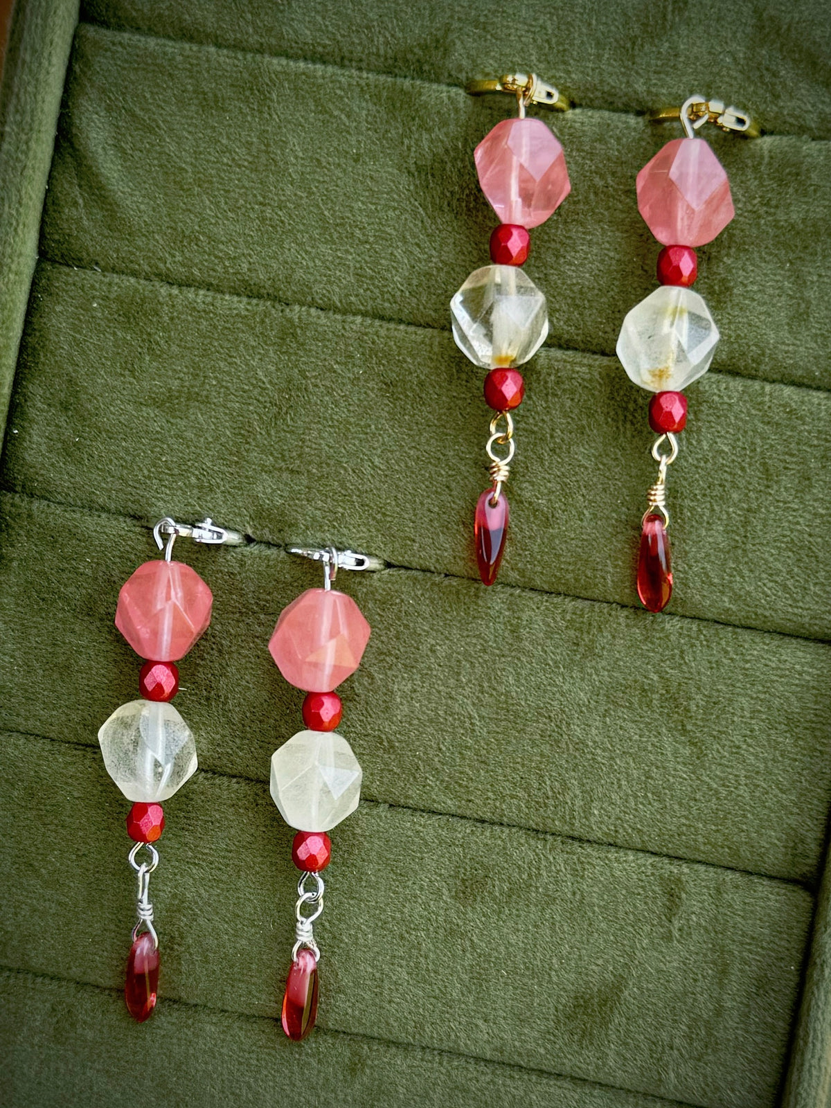 Handmade beaded earrings with gold and silver huggies, pink and crystal beads, and red dangling beads.