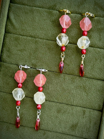Handmade beaded earrings with gold and silver huggies, pink and crystal beads, and red dangling beads.