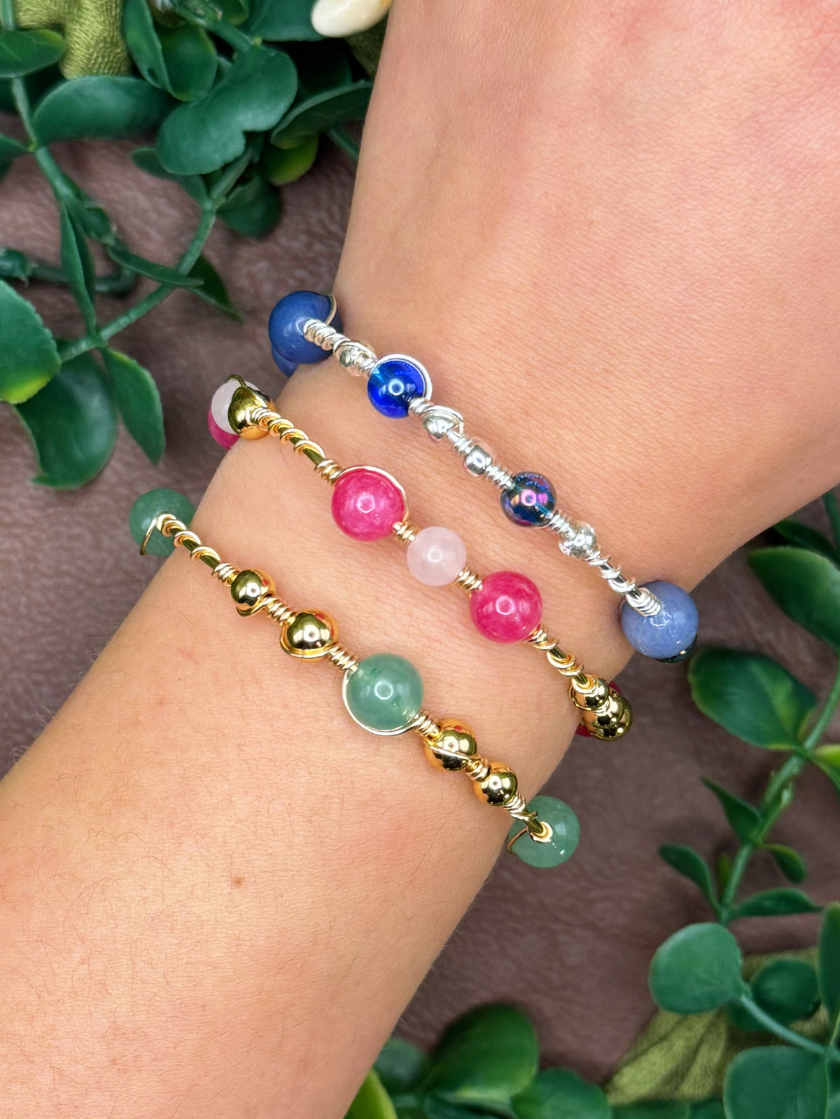 Handmade wire-wrapped bangle bracelets with quartz beads.