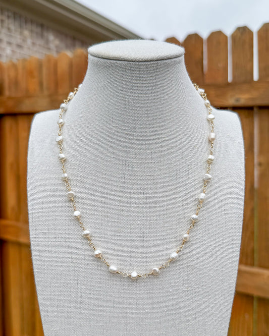 Beaded necklace featuring handmade gold wire links with pearls.