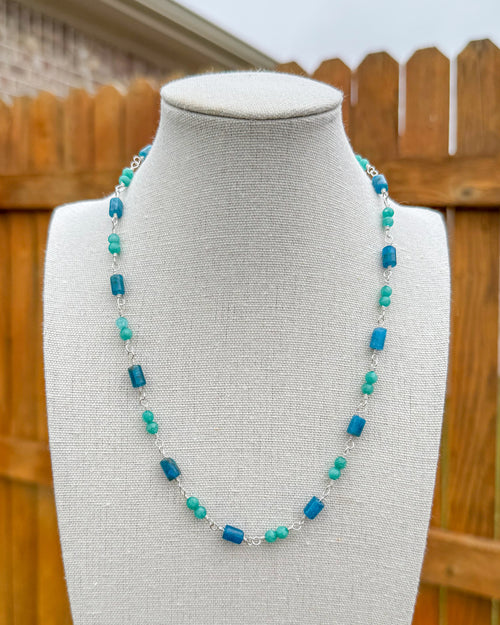 Beaded necklace featuring handmade wire links with blue and aqua gemstone beads.